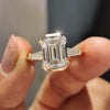 Emerald cut engagement ring with three stone design