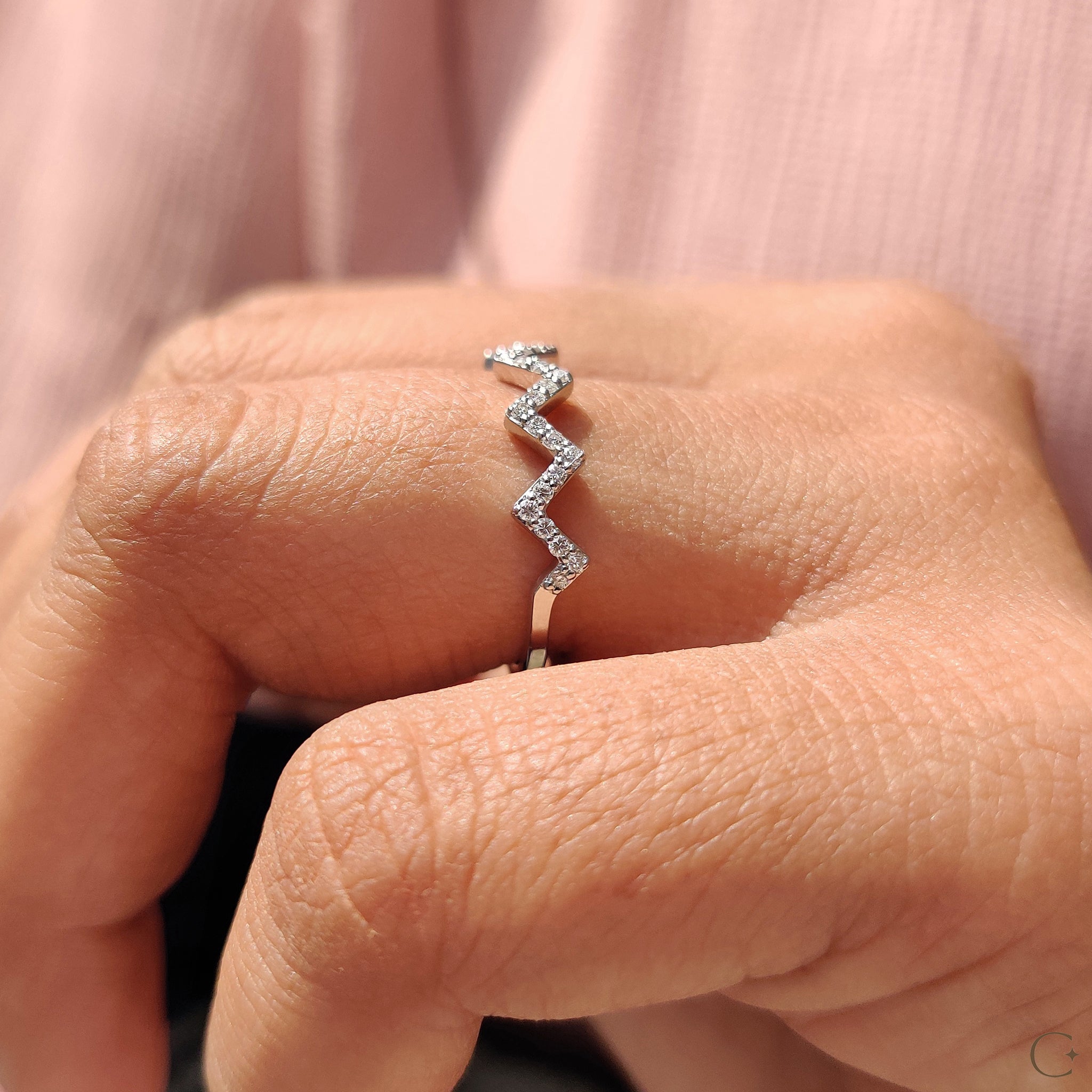 Round cut diamond band designed in a prong setting.
