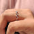 Round cut diamond band designed in a prong setting.
