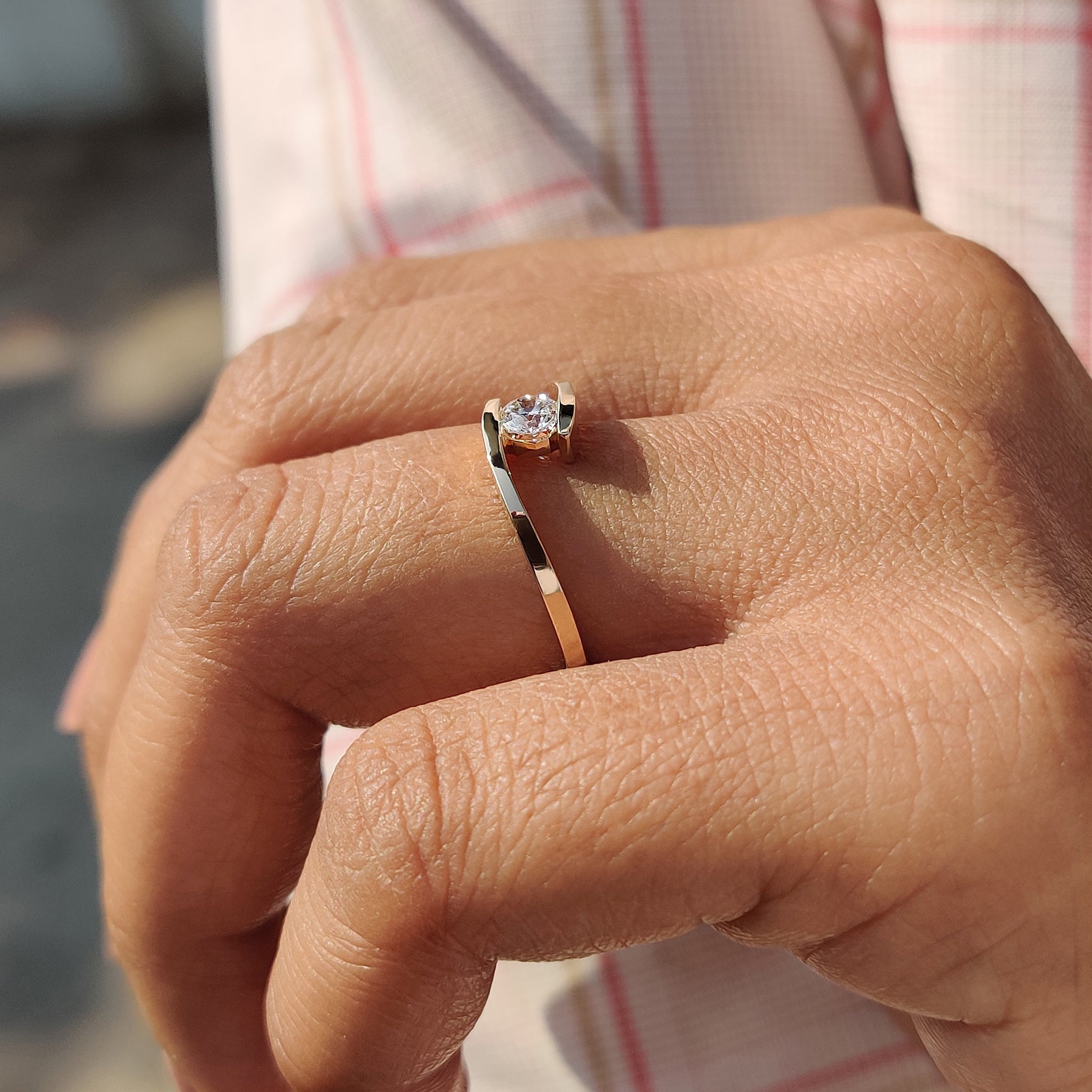 Solitaire setting ring featuring a single diamond.

