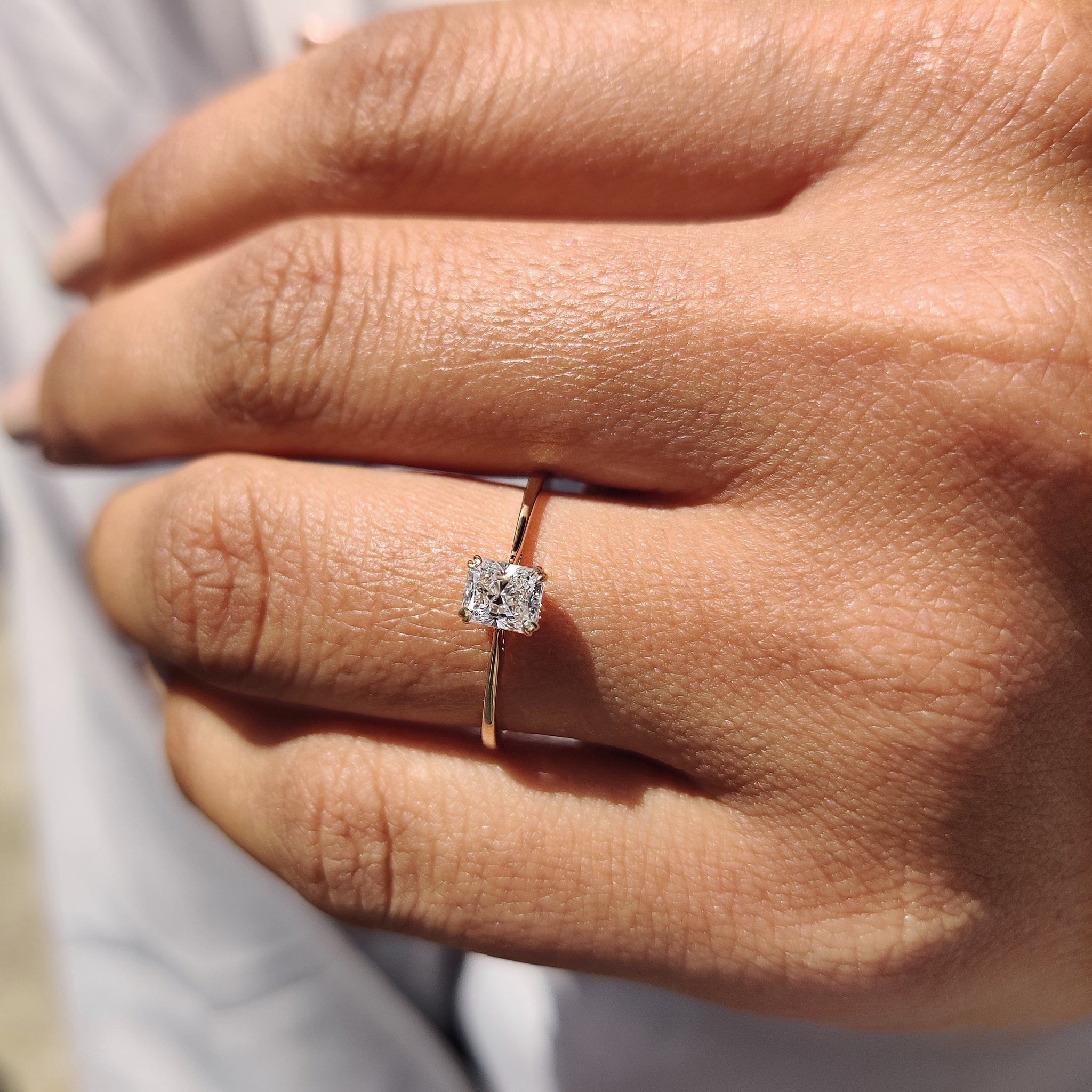 Tapered shank engagement ring with a brilliant diamond center.
