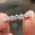 Round stone wedding band crafted with clean shape.