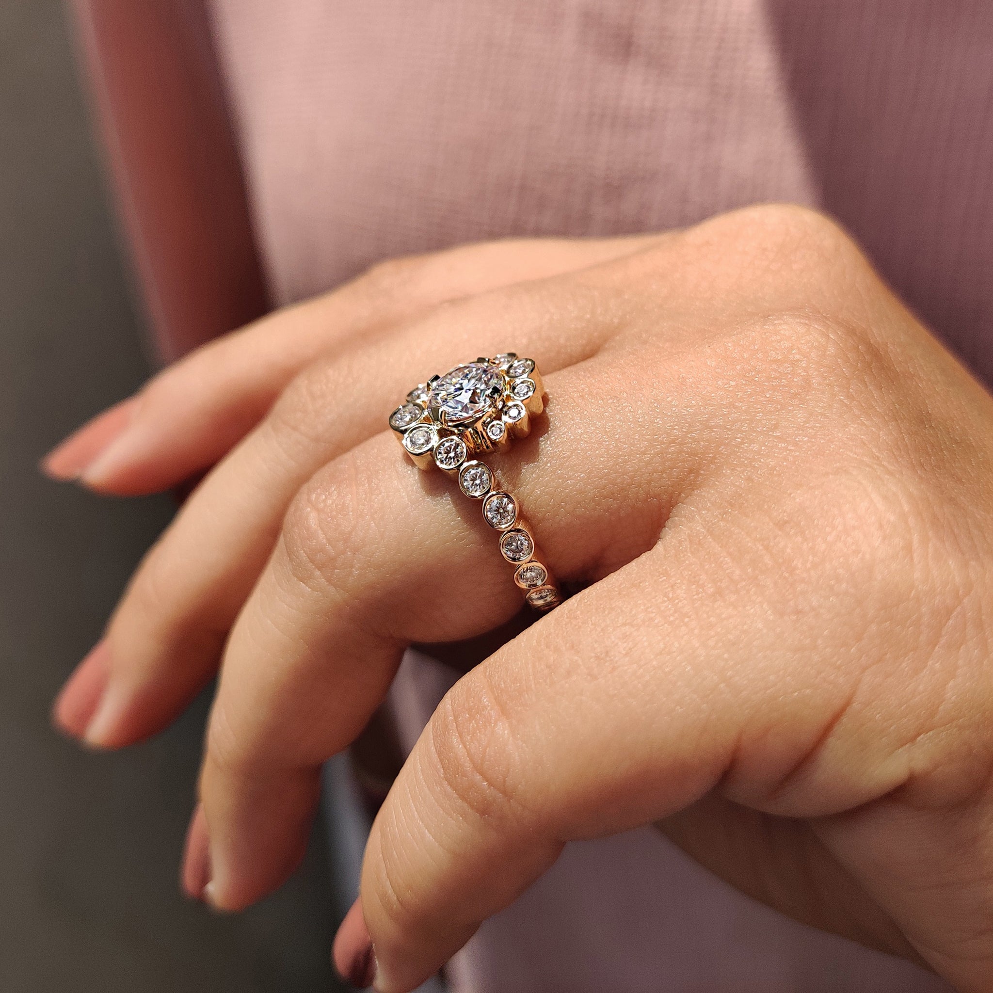 Buy engagement ring featuring round cut moissanite in a classic bezel setting.
