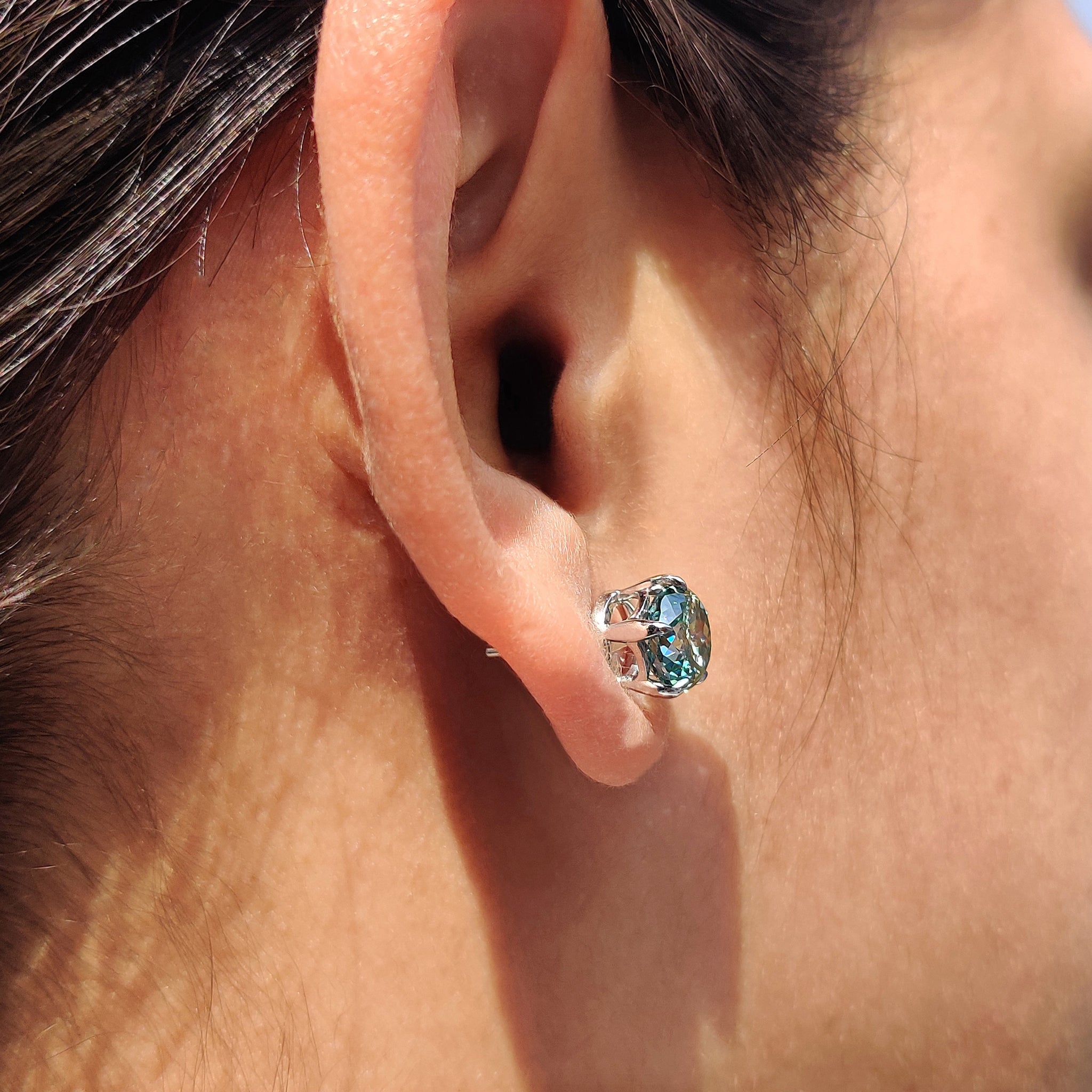 Cyan Blue Stud Earrings set with 5 prong earring settings and handmade earrings craftsmanship.
