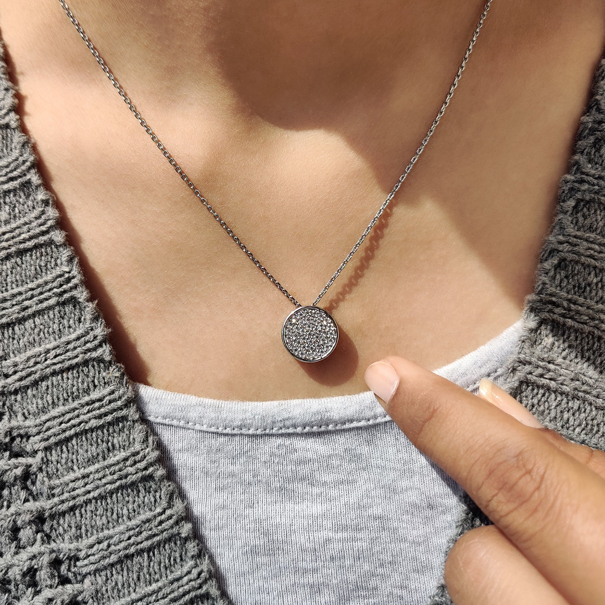 Carat Diamonds round diamond cluster pendant in white gold.
