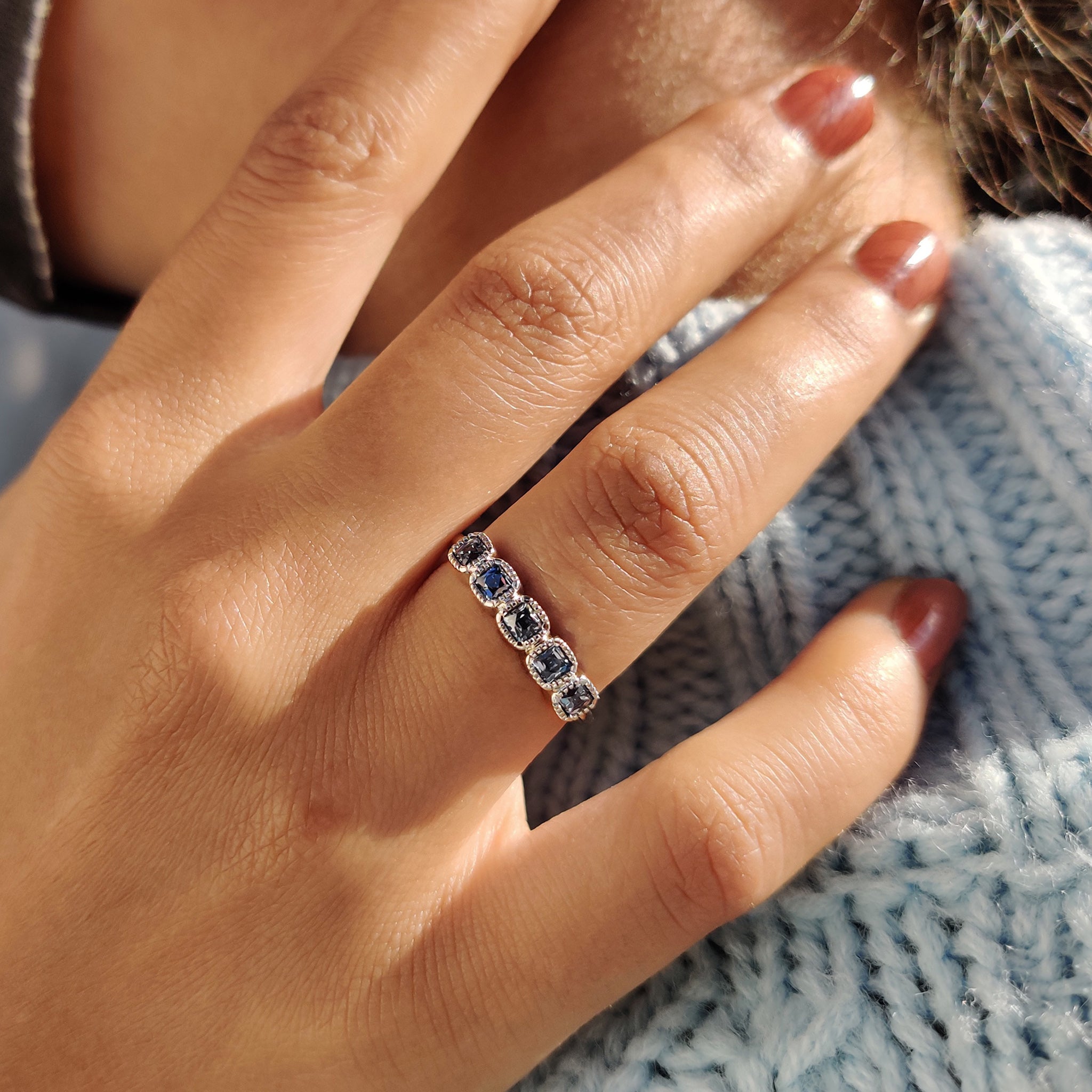 Custom handmade wedding band with dark blue stones.