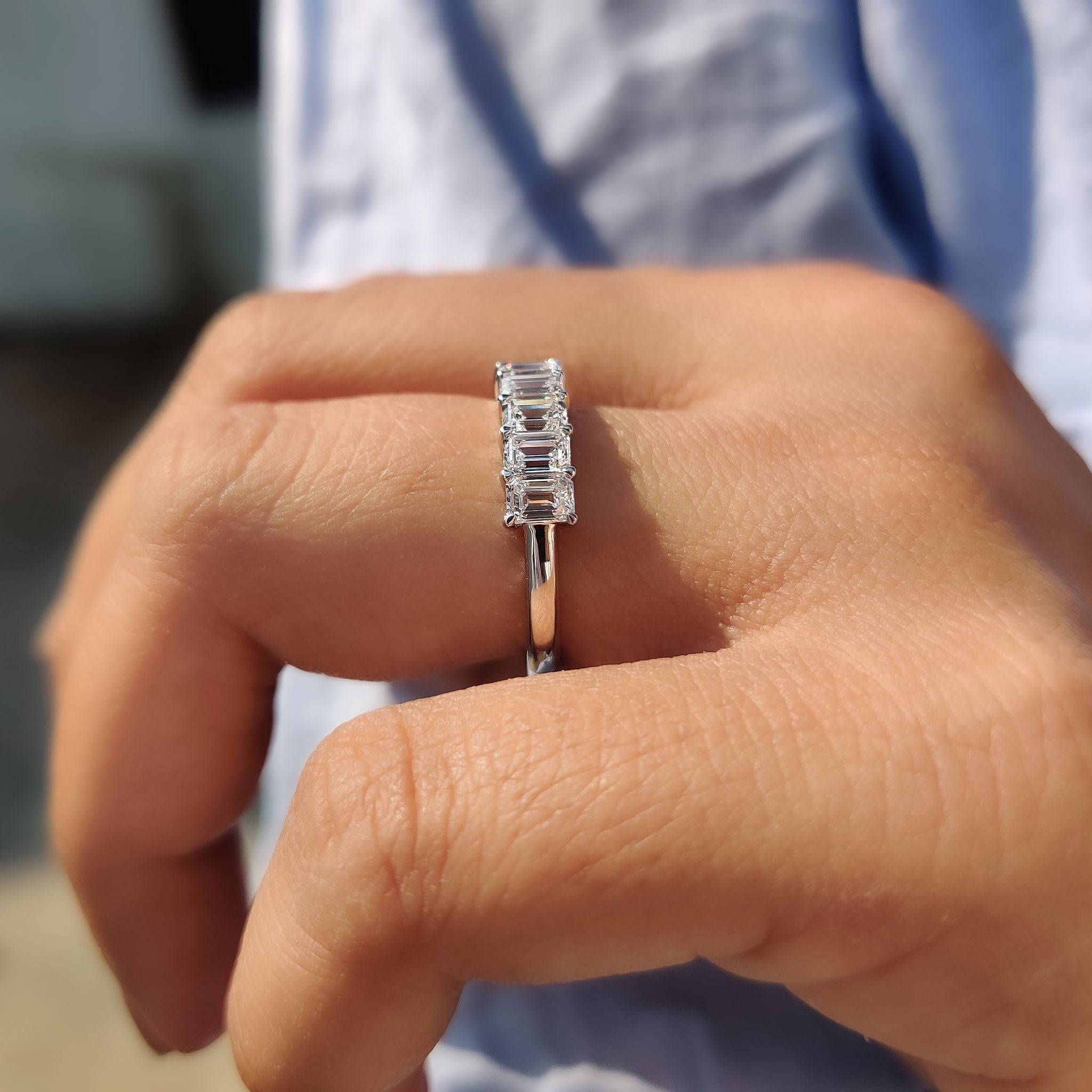 White gold prong set wedding band featuring lab-grown diamonds.
