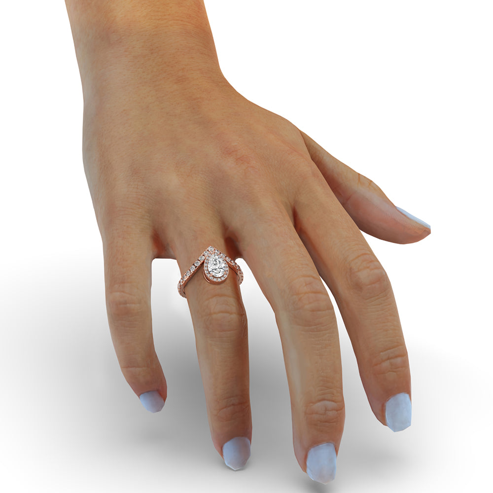 Teardrop halo ring designed with a pave setting, adding brilliance to the pear shaped diamond center stone.