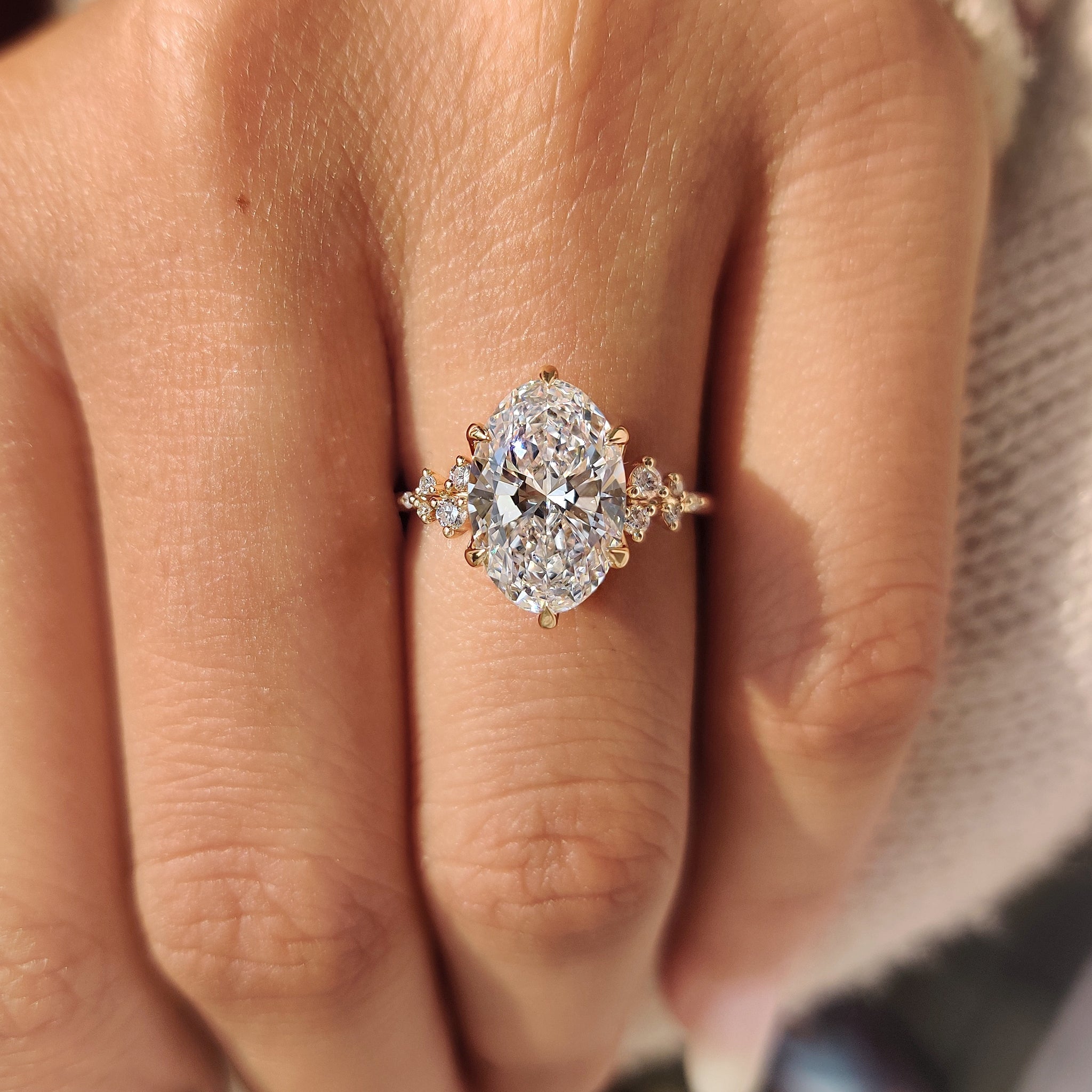 Handmade oval diamond ring with round side stones.
