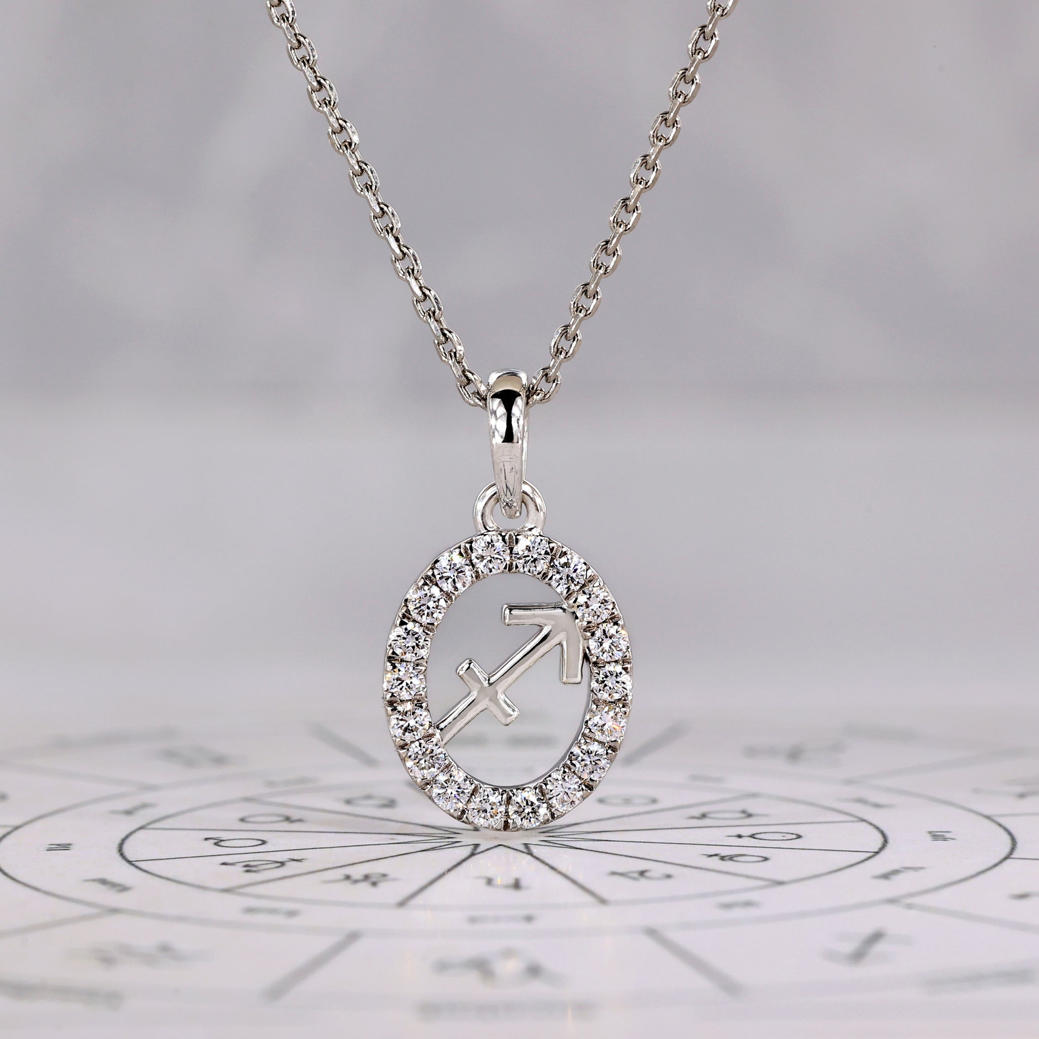Sagittarius pendant in white gold featuring a halo diamond and zodiac design.