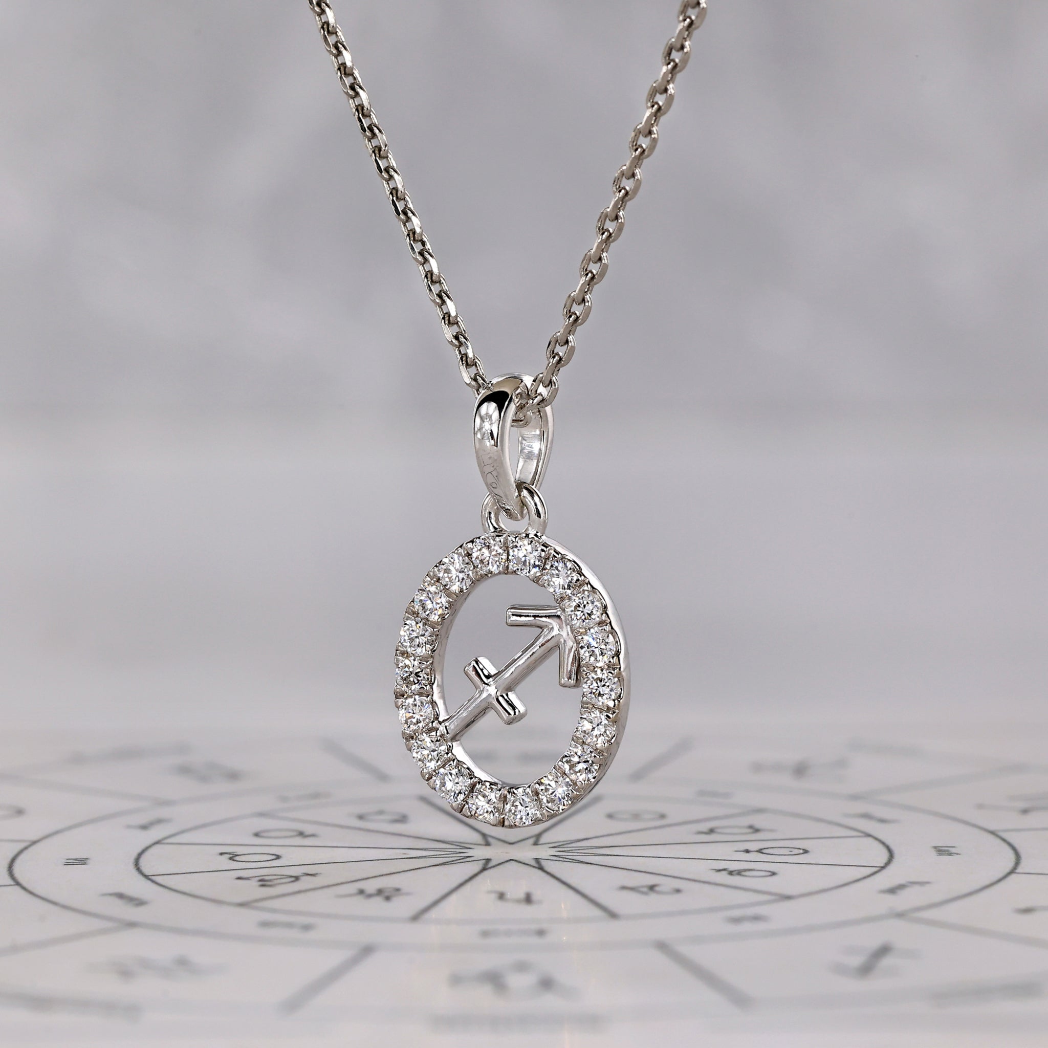 Handmade horoscope pendant for Sagittarius in white gold with diamond accents.
