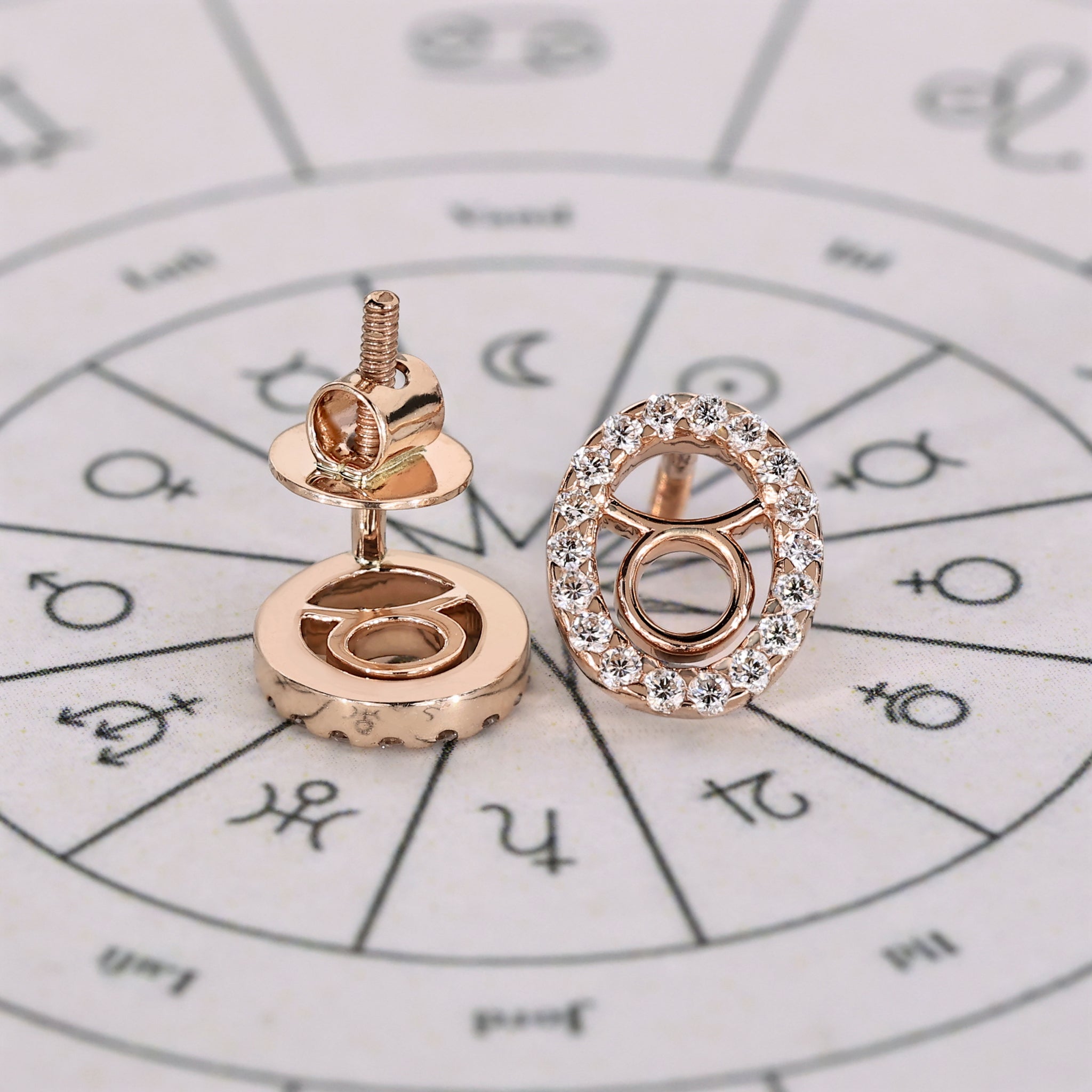 Carat Diamonds Taurus earrings in rose gold with round halo diamonds.
