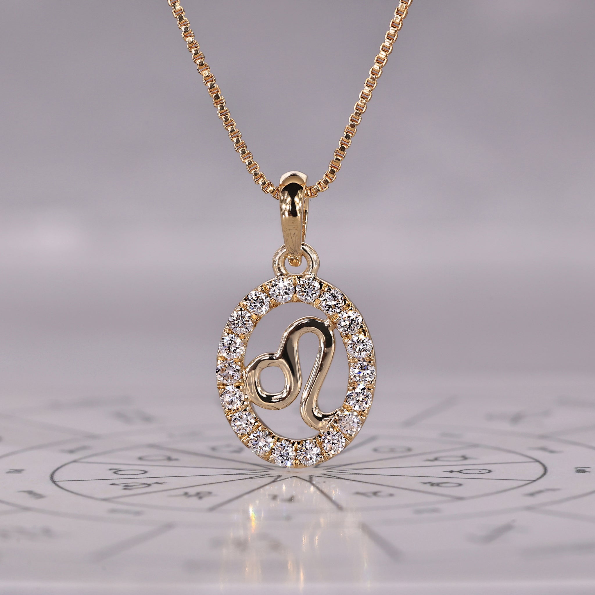 Gold Leo pendant with halo diamond and round cut design.