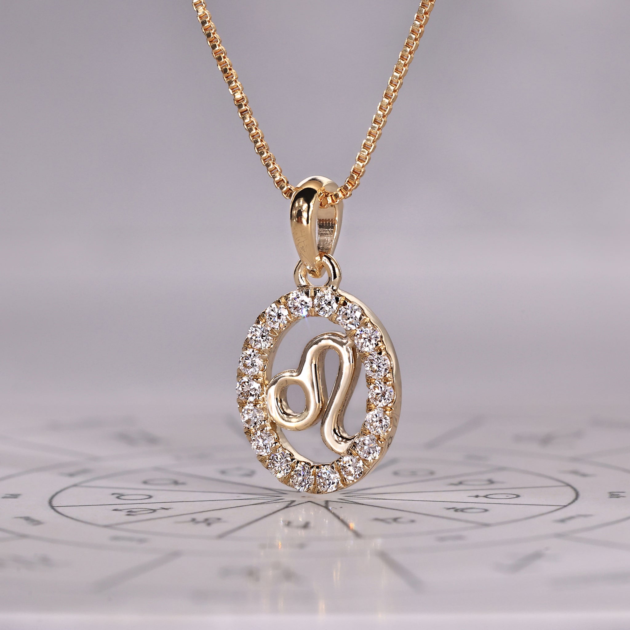 Astrology pendant featuring Leo constellation design in yellow gold finish.
