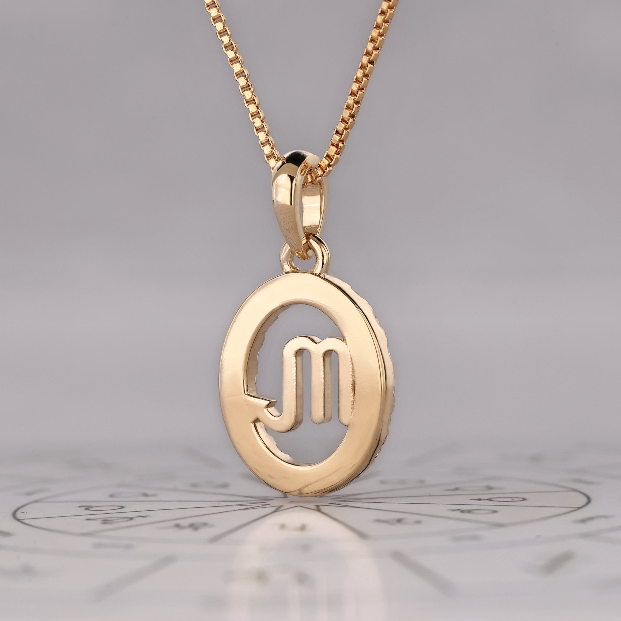 Carat Diamonds Scorpio zodiac pendant in gold with halo diamond setting.