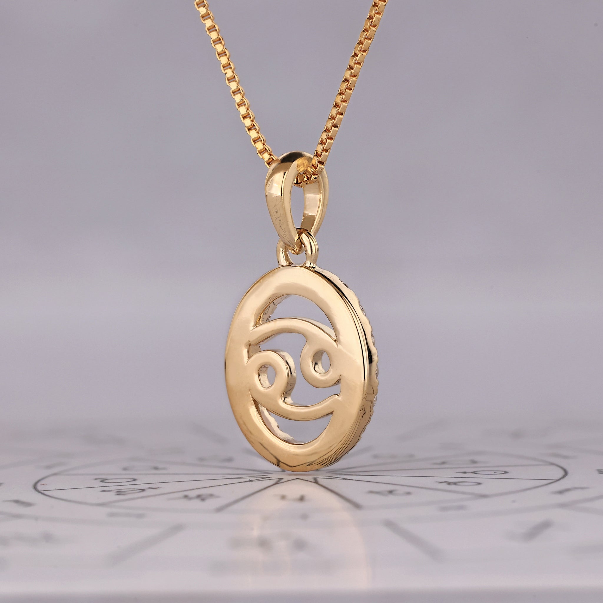 Astrology pendant featuring Cancer constellation design in yellow gold finish.