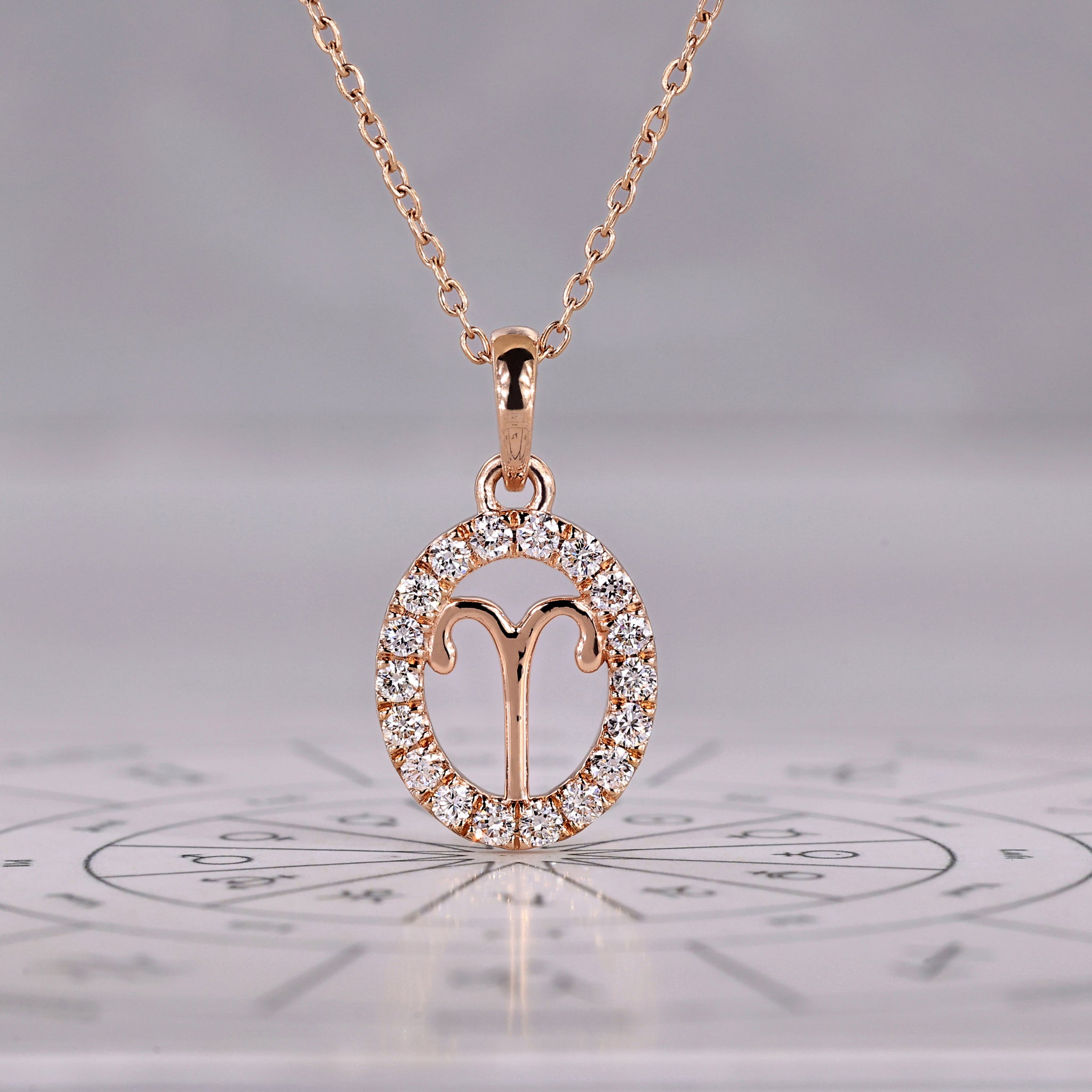 Rose gold Aries pendant with halo diamond and round cut design.