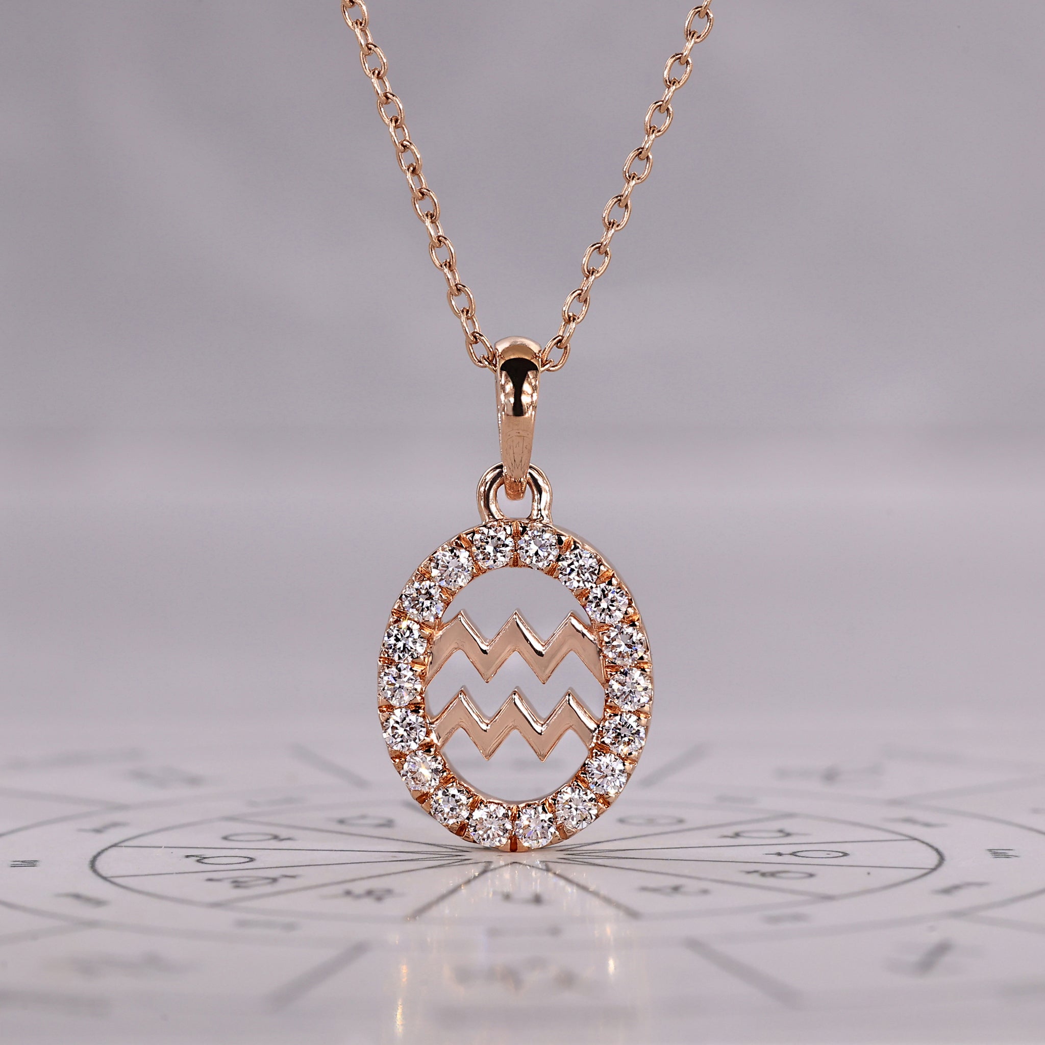 Gold Aquarius pendant with halo diamond and round cut design.