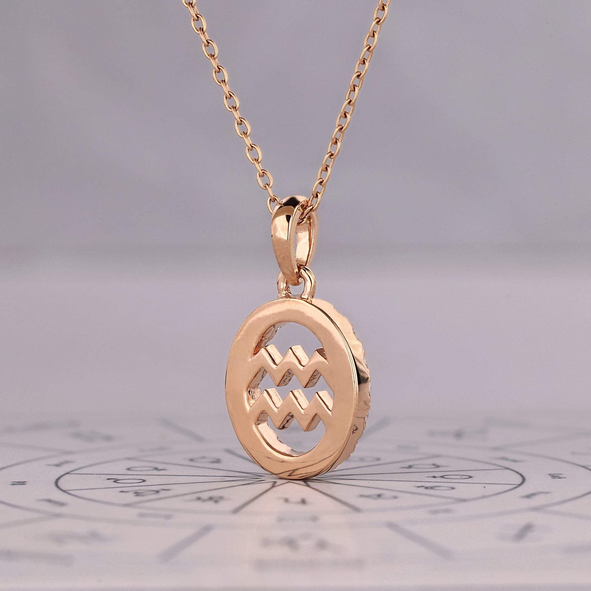 Aquarius pendant in rose gold with round diamond halo detailing.
