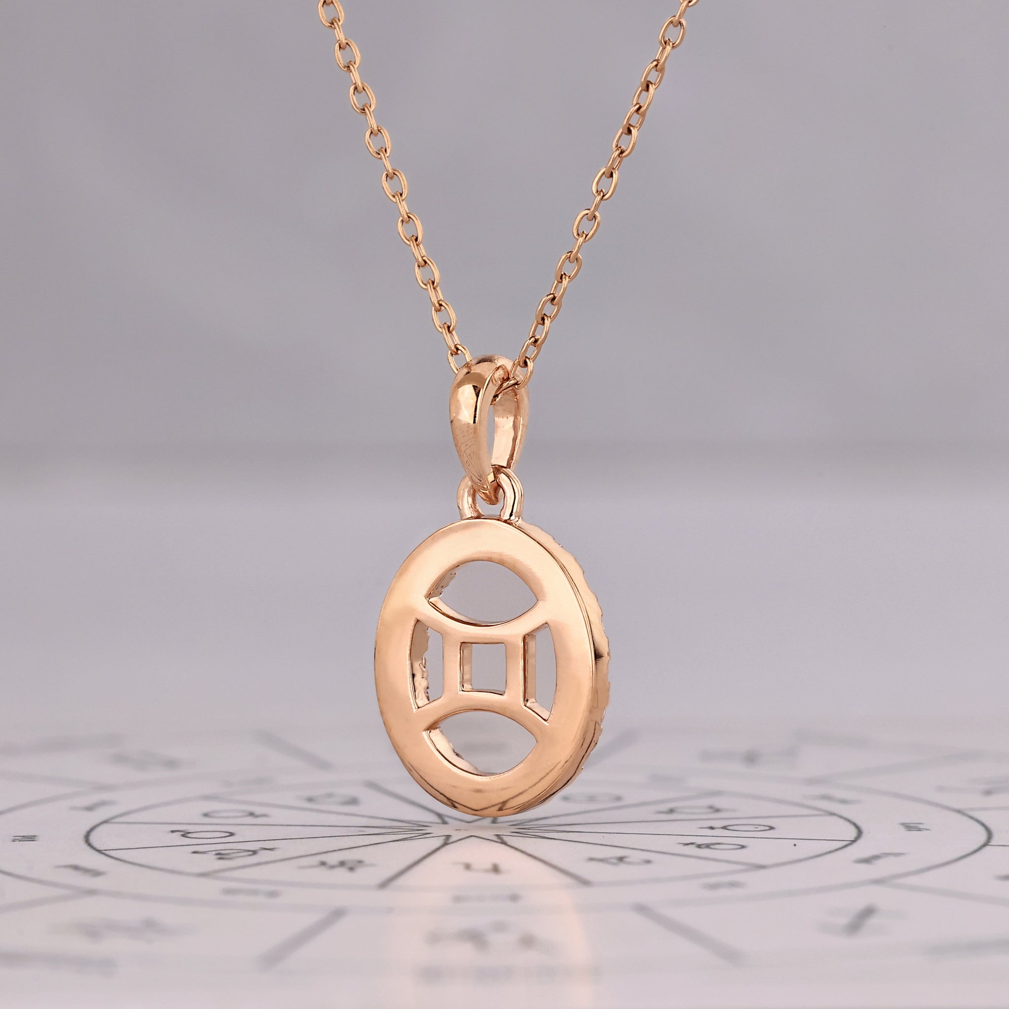 Gemini pendant in rose gold with round diamond halo detailing.