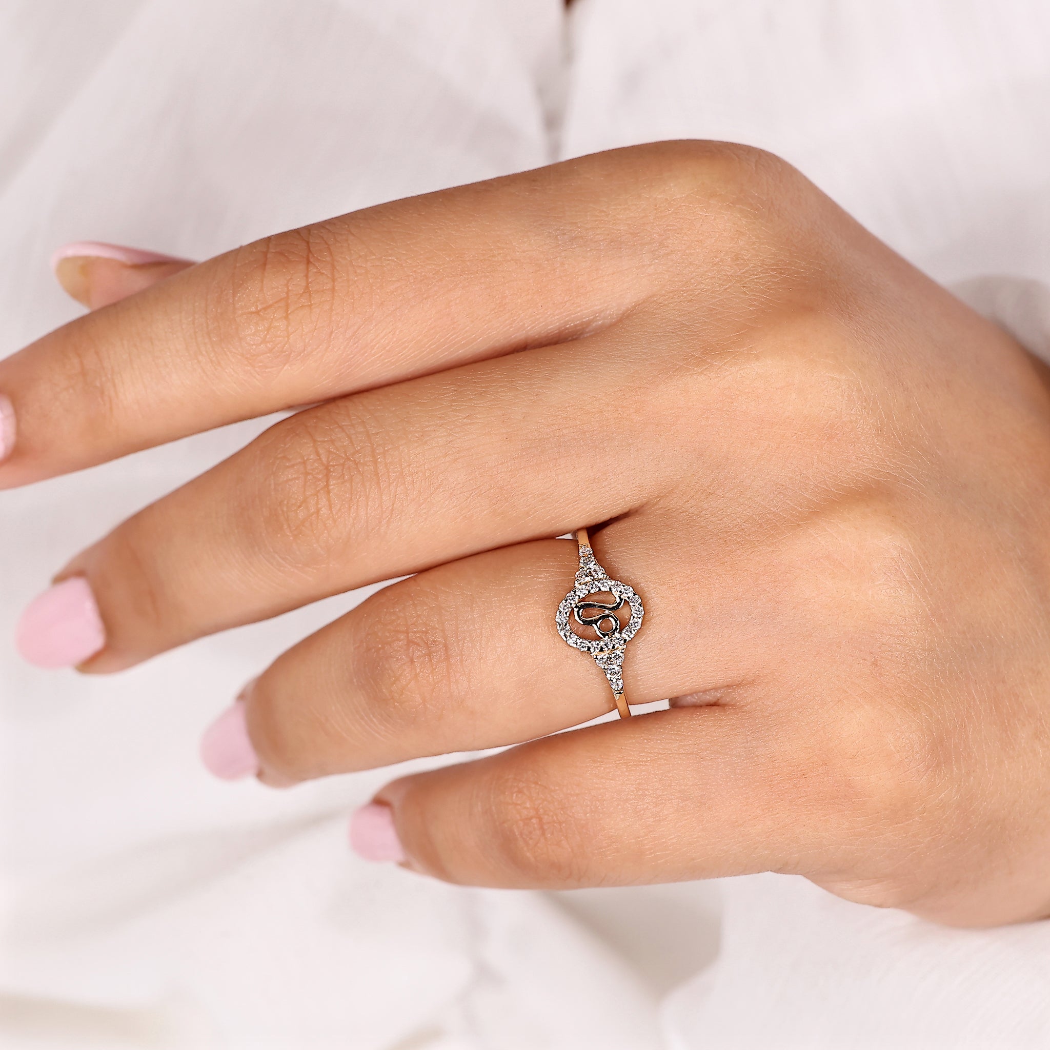 Carat Diamonds Leo ring with halo diamond design in yellow gold.
