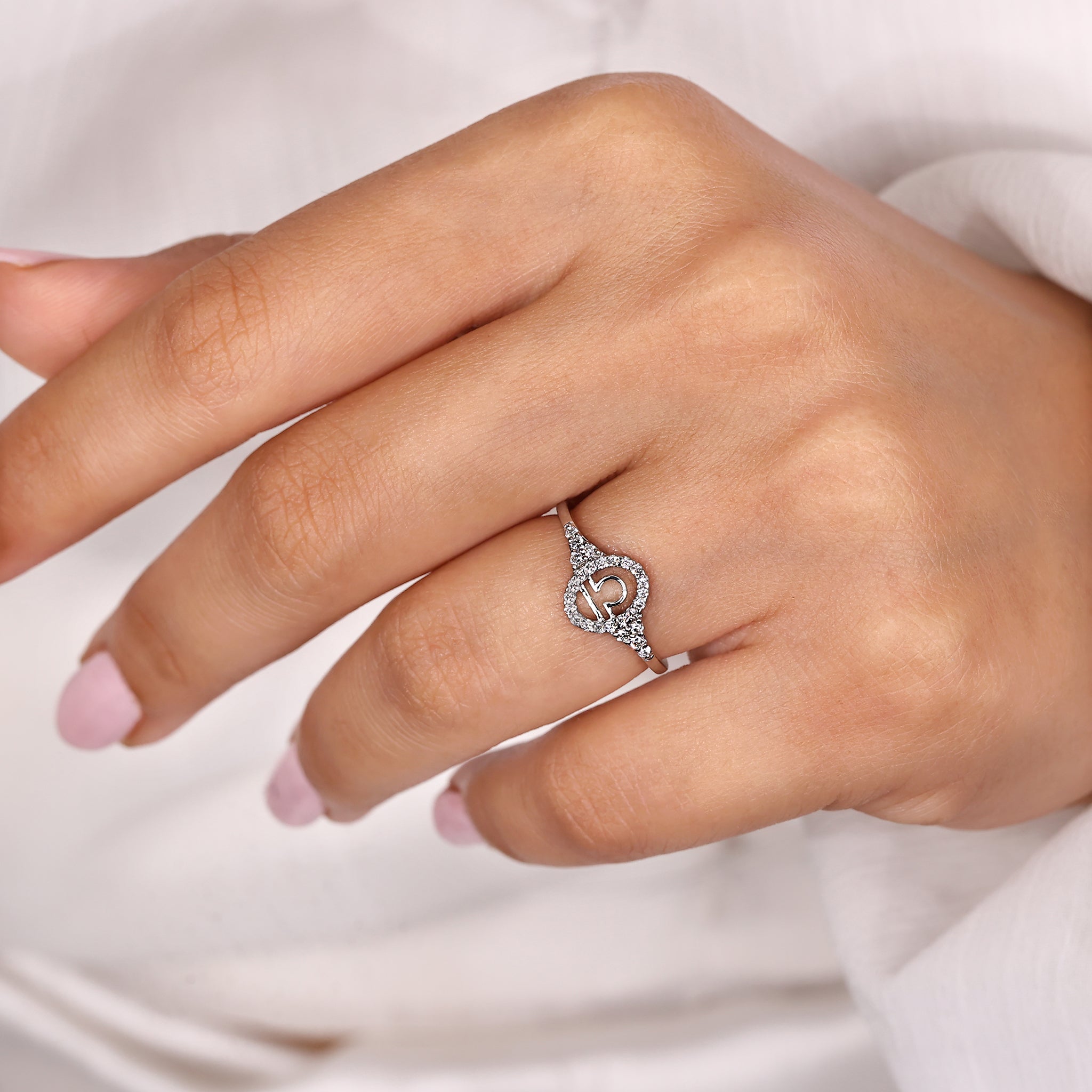 Custom zodiac ring with Libra horoscope design in white gold finish.
