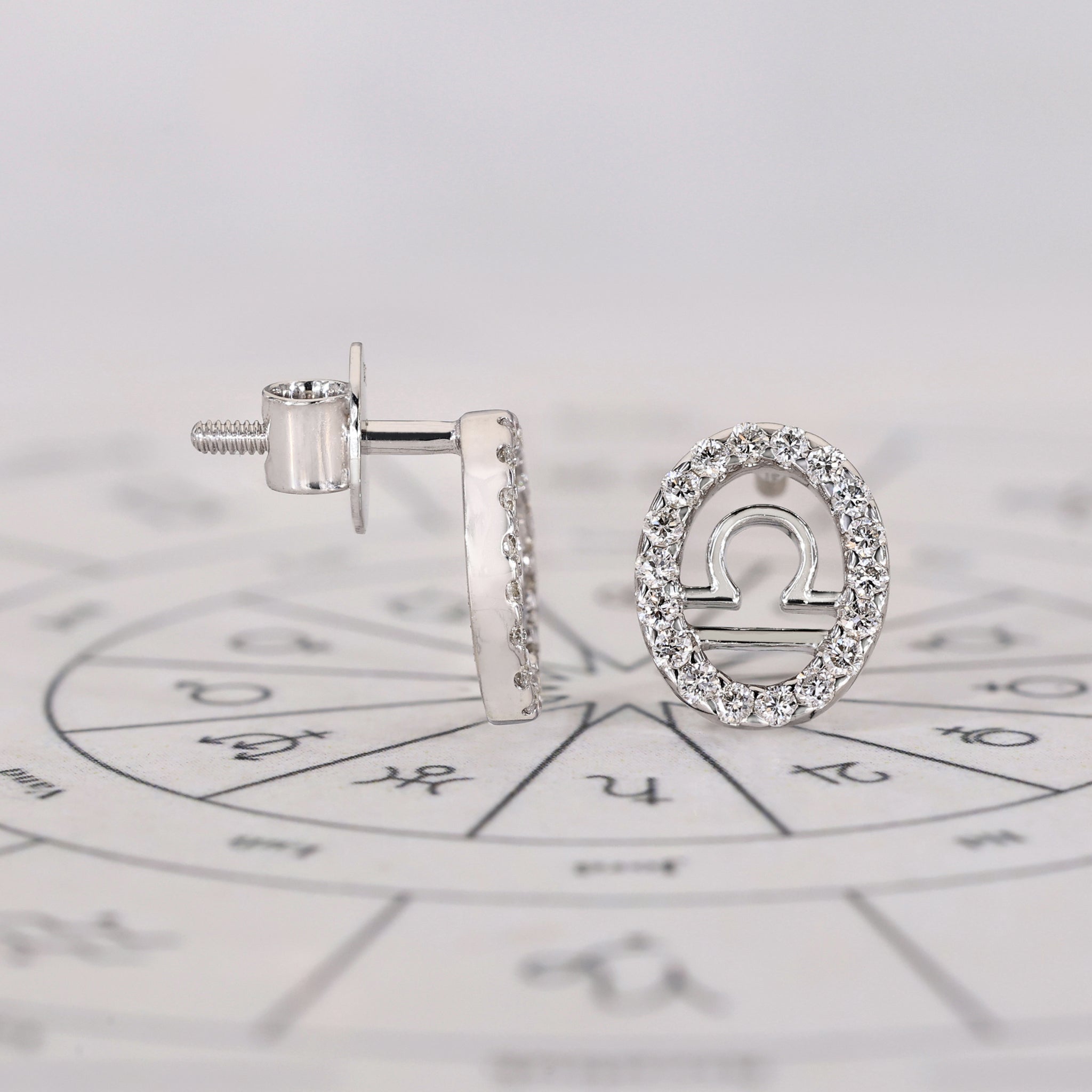 Libra stud earrings handcrafted with halo diamonds.
