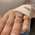 A handmade jewelry piece, this toi et moi engagement ring highlights a pear cut diamond and a princess cut diamond with a prong setting.
