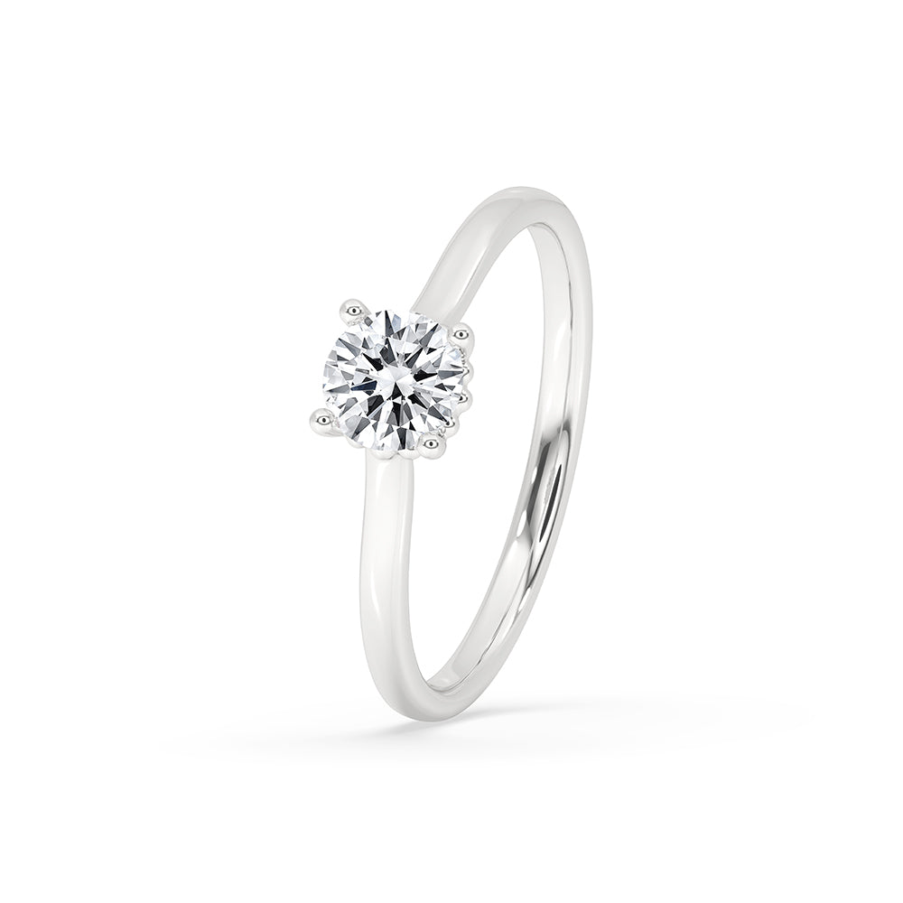 White gold engagement ring featuring a round cut diamond.
