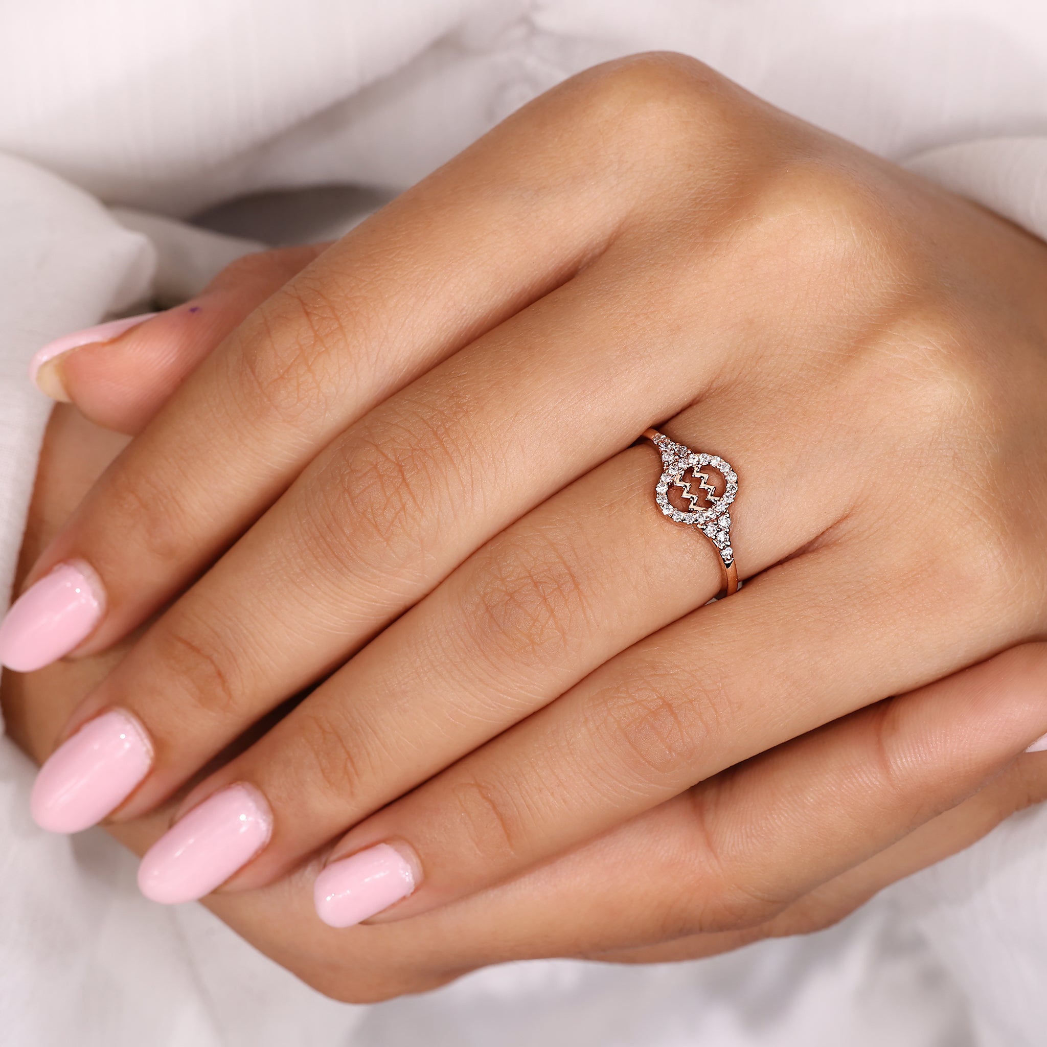 Buy engagement ring featuring Aquarius zodiac sign and rose gold finish.
