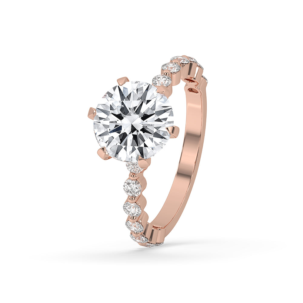 Rose gold engagement ring featuring a round cut center and round cut side stone.
