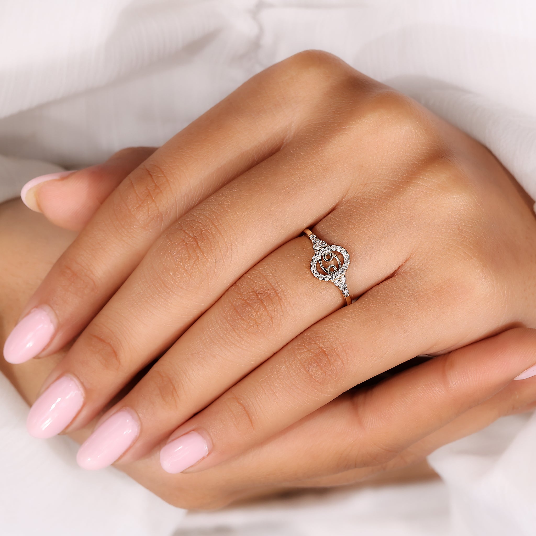 Cancer zodiac constellation ring with halo diamond and round side stone detailing.
