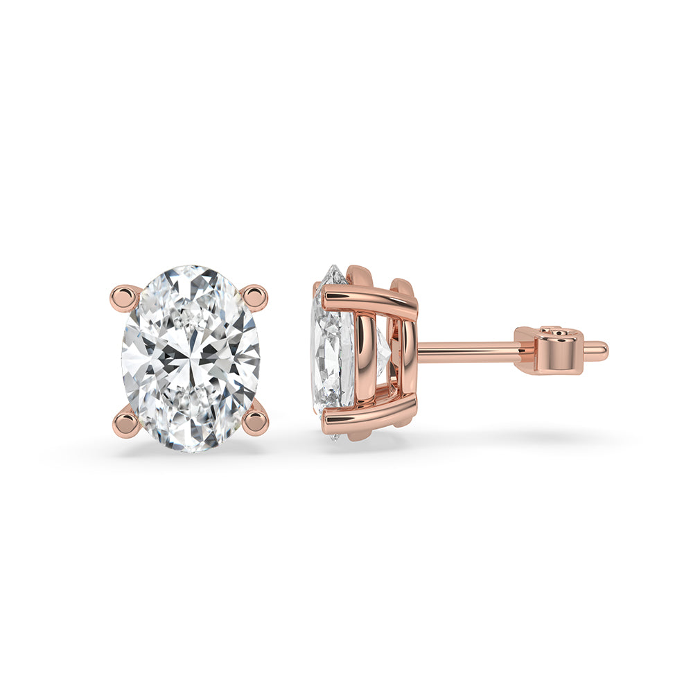 Gold stud earrings with oval cut diamonds and handmade craftsmanship.
