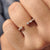Rose gold wedding band with a floating bubble prong band and open gap wedding band.