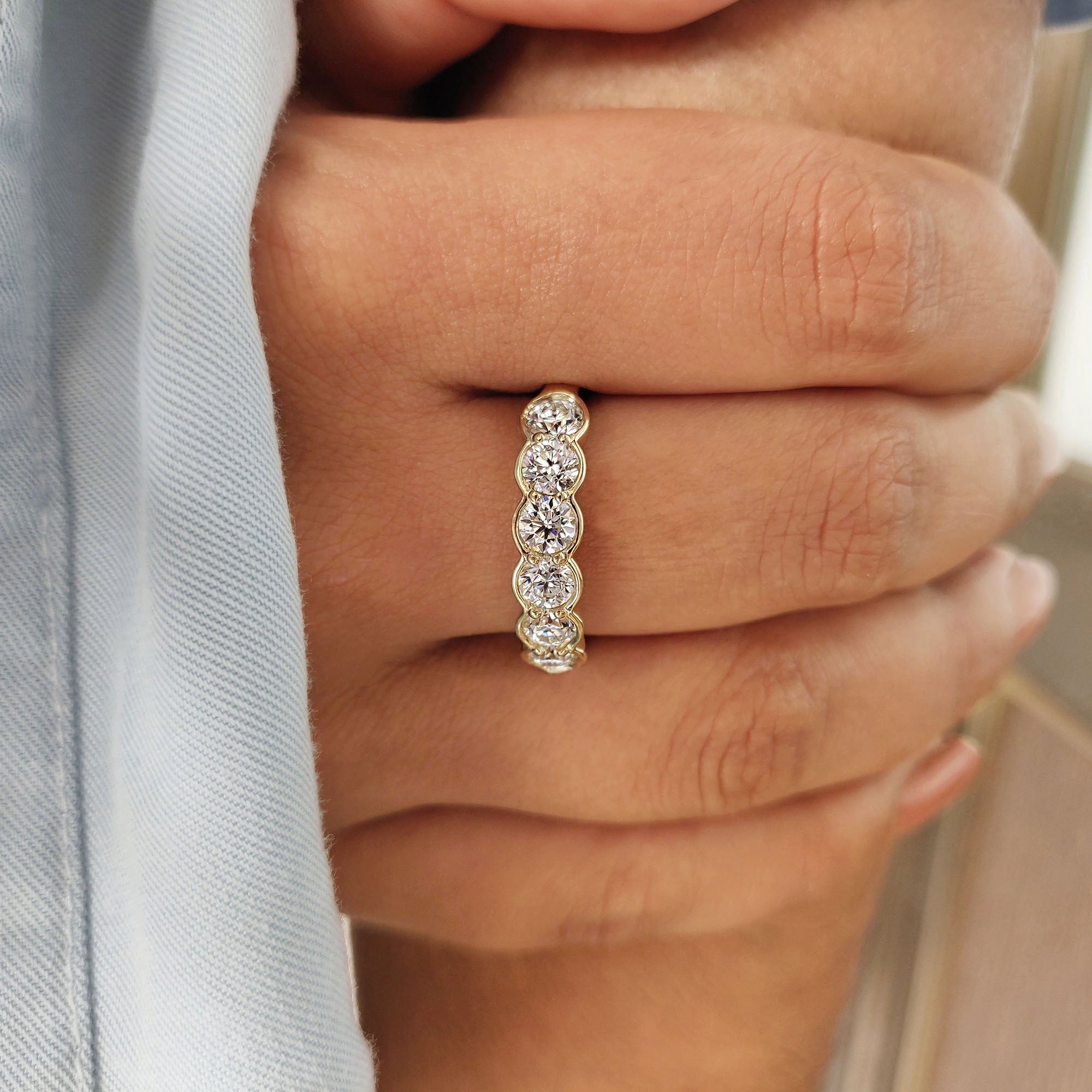 Buy moissanite band with a 6 stone bezel set in a half eternity design.
