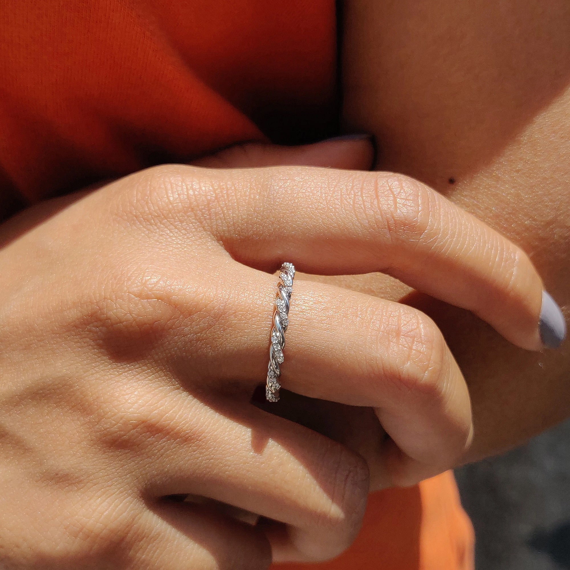 White gold moissanite band with twisted design
