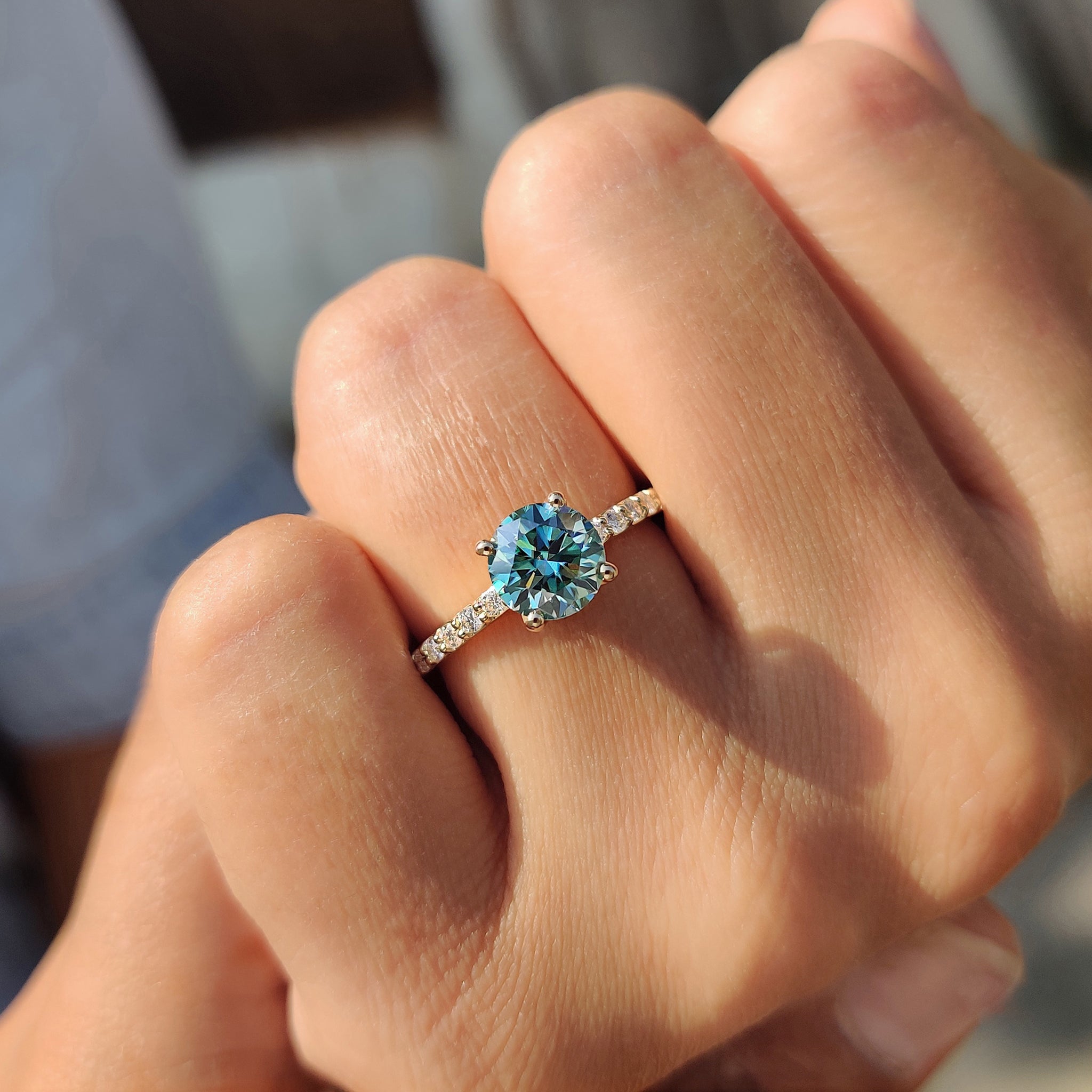 Go with a carat diamonds ring that includes a cyan blue round cut ring for a bold look.

