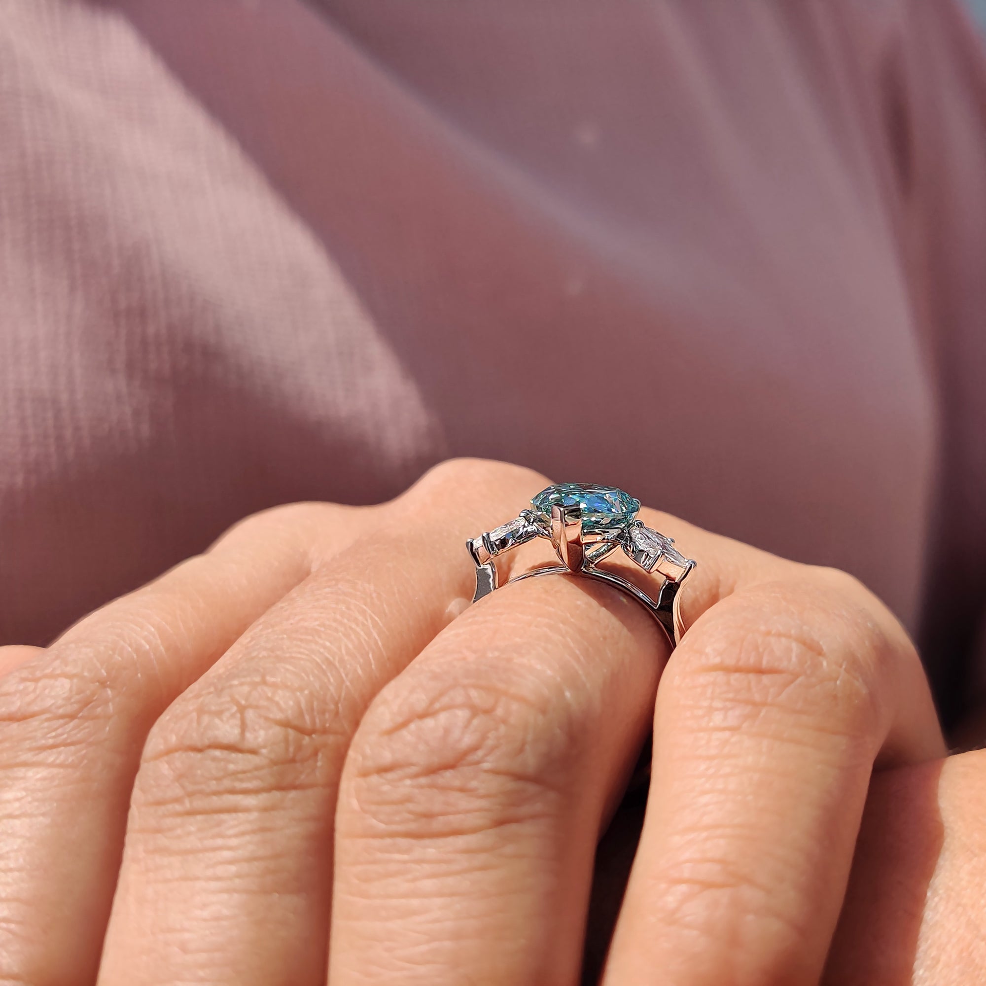 Best place to buy an engagement ring featuring a unique pear cut cyan blue Moissanite.
