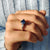 Round cut engagement ring set in a three stone tapered design.
