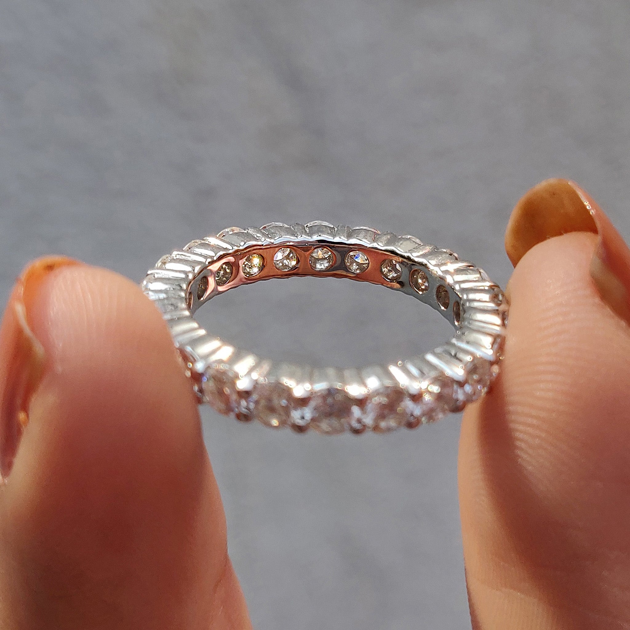 Custom moissanite band matches beautifully with moissanite wedding band.
