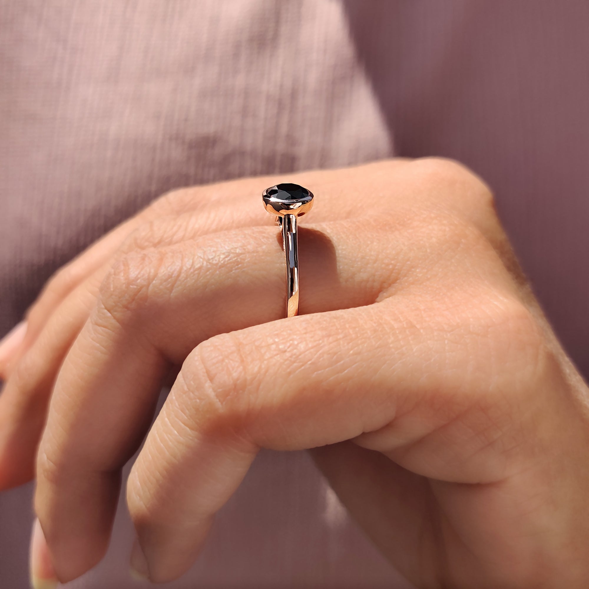 Women’s anniversary ring featuring black round cut Moissanite and handmade jewelry style.
