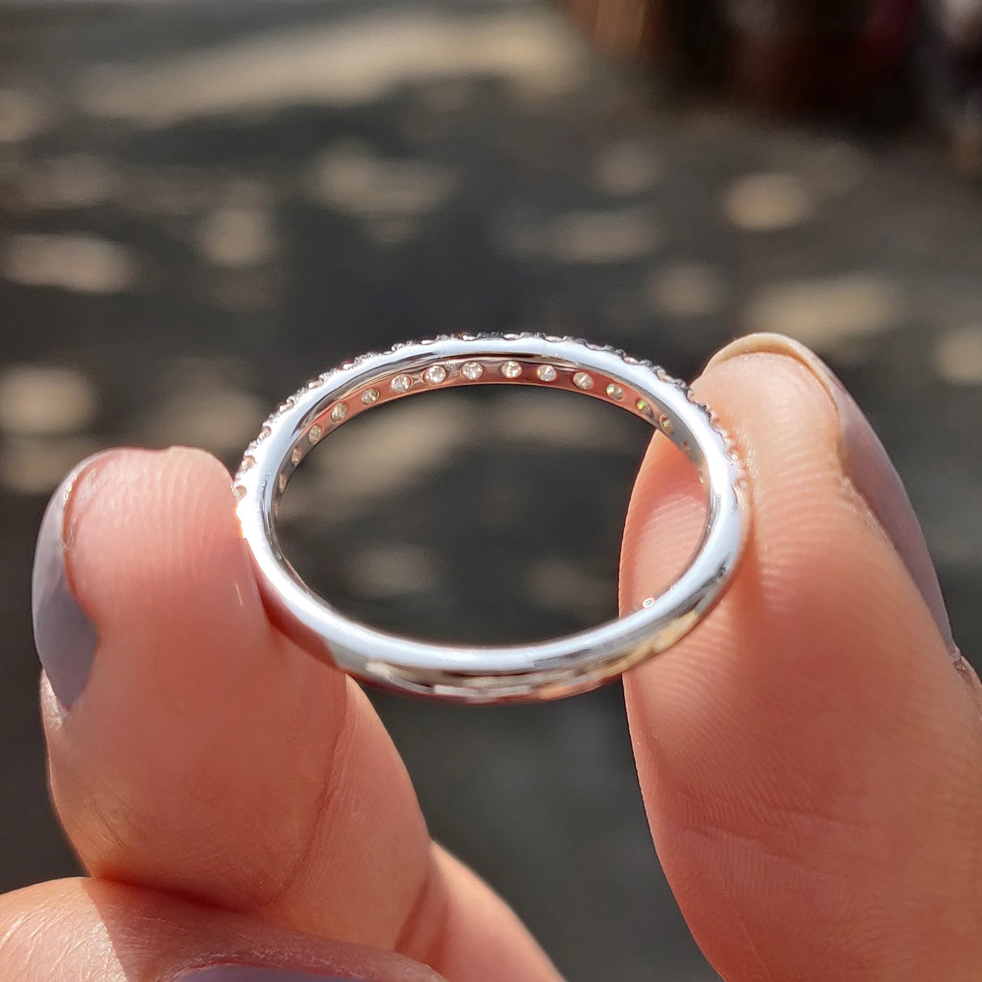 Round moissanite wedding band complements custom wedding band.
