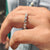 Moissanite wedding band in a full eternity shared prong setting for all-around brilliance.
