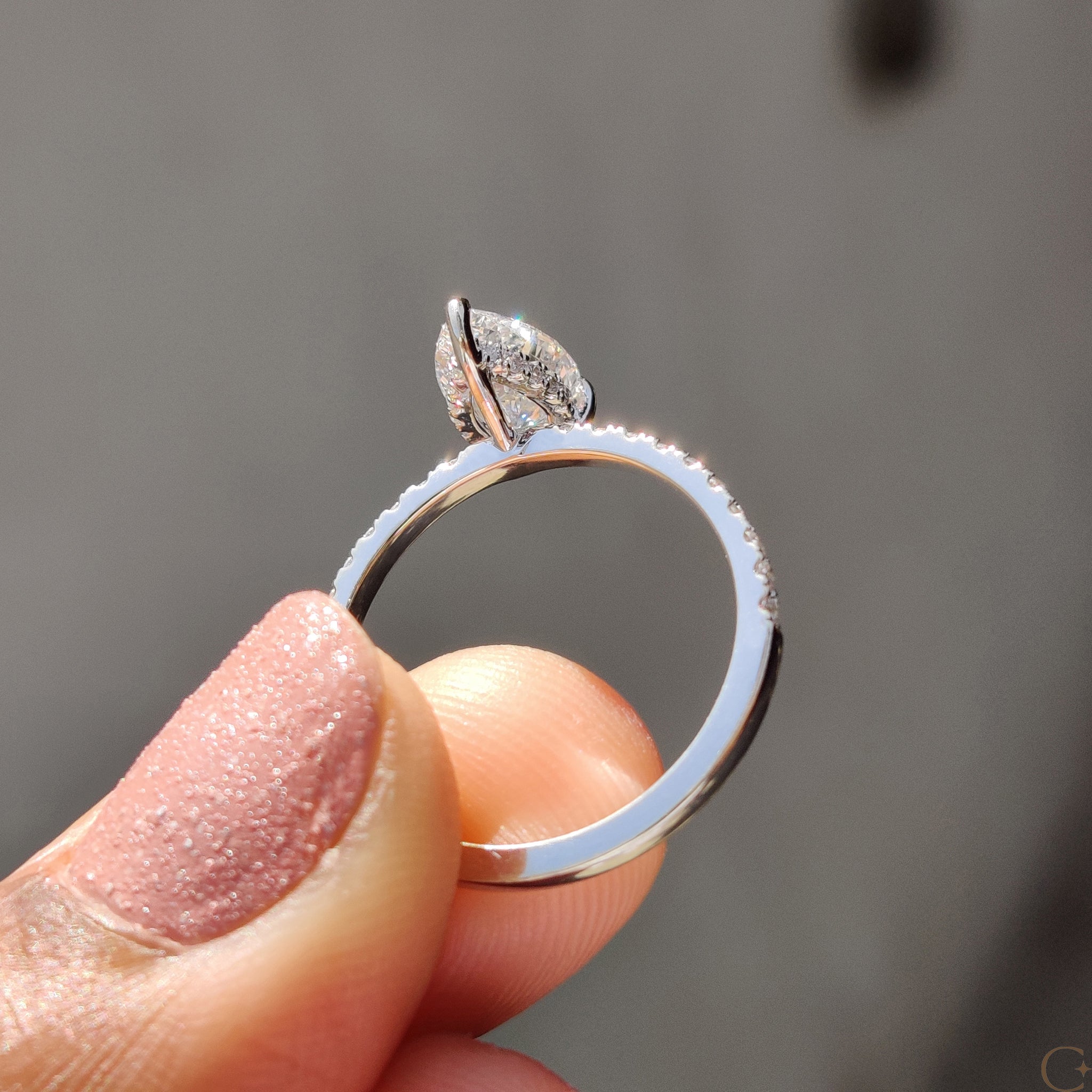 Unique handmade jewelry showcasing a pear cut diamond.
