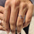 Minimalist wedding band with astrological symbol and moissanite.