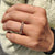 Round moissanite band with a sleek design, crafted in yellow gold for a polished finish.