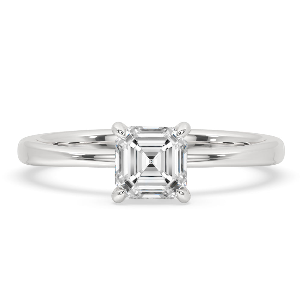 Asscher cut diamond solitaire engagement ring with a 4 prong setting on finger, perfect for timeless elegance.

