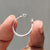 White gold band with two round  stones and a unique open cuff structure.
