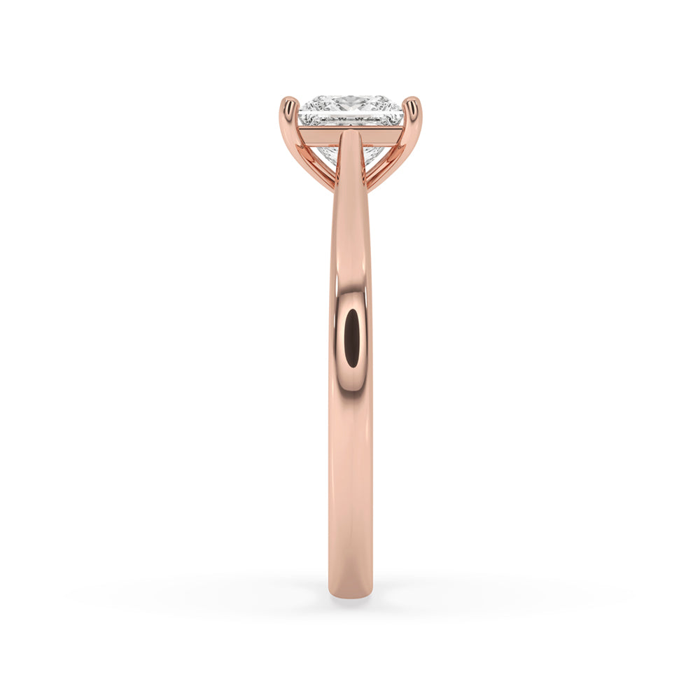 A stunning Princess Cut Solitaire Diamond Ring with a cathedral setting, available in rose gold.
