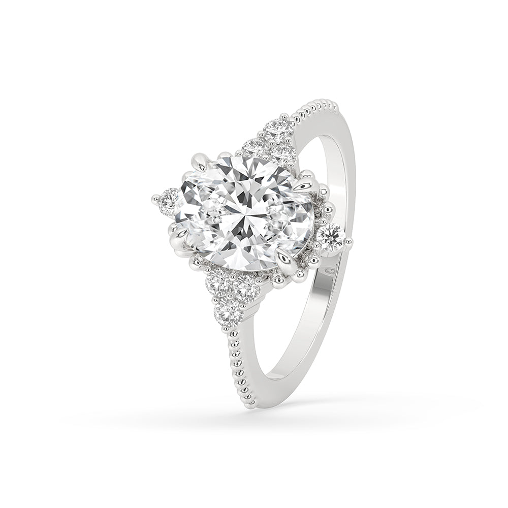 Round side stone engagement ring with fishtail prong setting.
